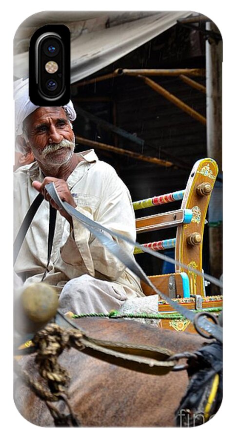 Man iPhone X Case featuring the photograph Smiling man drives horse carriage in Lahore Pakistan by Imran Ahmed