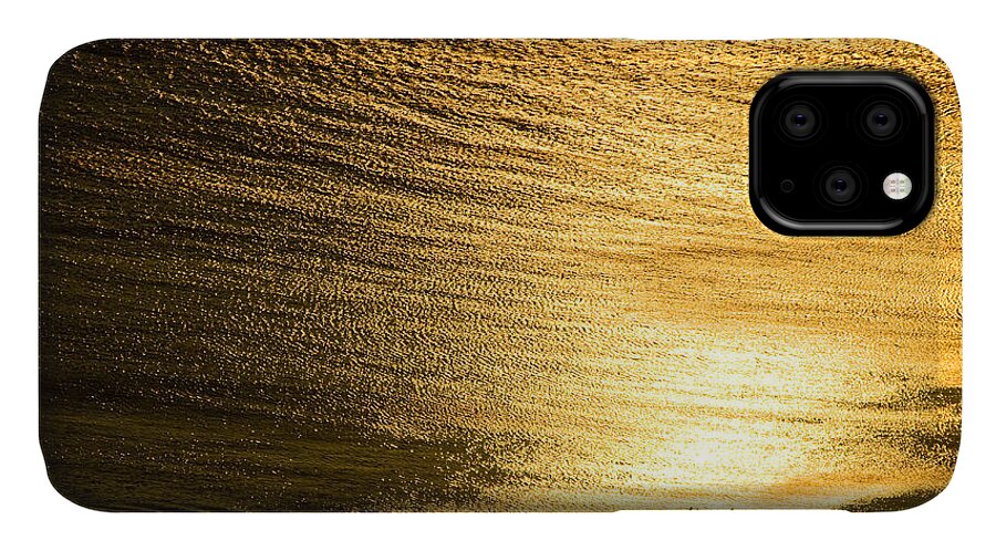 Water iPhone 11 Case featuring the photograph Golden sea with boat at sunset by Raimond Klavins