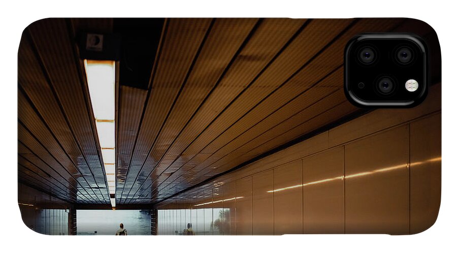 Architecture iPhone 11 Case featuring the photograph Passengers in a hurry at the end of a tunnel at the entrance to the metro station. by Joaquin Corbalan