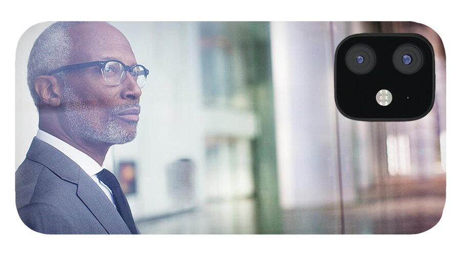 Corporate Business iPhone 12 Case featuring the photograph Black Businessman Looking Out Window by Hill Street Studios Llc