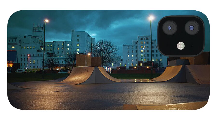 Apartment iPhone 12 Case featuring the photograph Cityscape And Skateboard Park At Night by Peter Muller