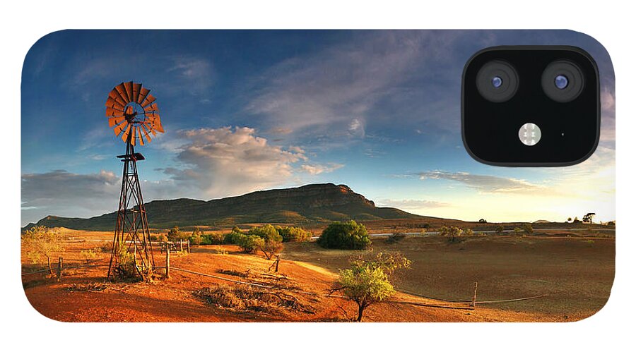 First Light Early Morning Windmill Dam Rawnsley Bluff Wilpena Pound Flinders Ranges South Australia Australian Landscape Landscapes Outback Red Earth Blue Sky Dry Arid Harsh iPhone 12 Case featuring the photograph First Light on Wilpena Pound by Bill Robinson