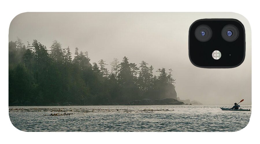 Scenics iPhone 12 Case featuring the photograph Kayaker Approaching Shore Of Bc Island by Stuart Mccall