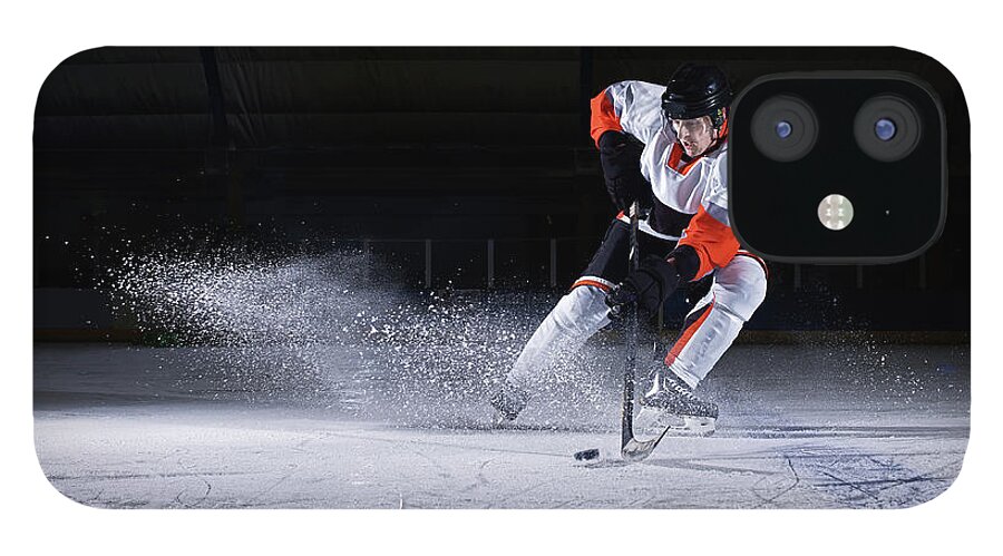 Focus iPhone 12 Case featuring the photograph Male Ice Hockey Player Taking Puck by Mike Harrington