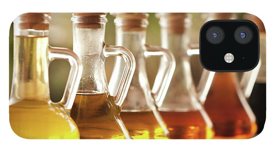 In A Row iPhone 12 Case featuring the photograph Olive Oil And Vinegar In Bottles On The by Ralucahphotography.ro
