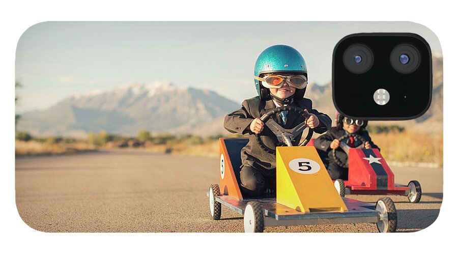 Cool Attitude iPhone 12 Case featuring the photograph Young Boy Races Toy Car Wearing by Richvintage