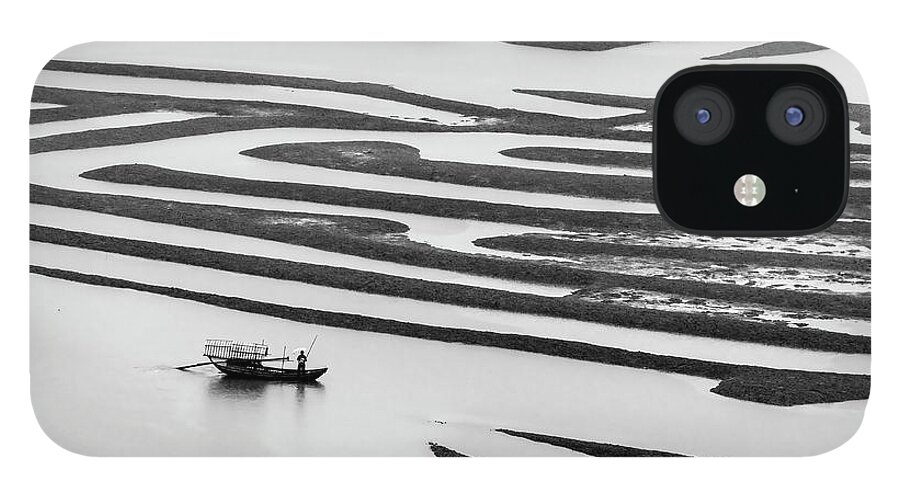 Asia iPhone 12 Case featuring the photograph A solitary boatman. by Usha Peddamatham