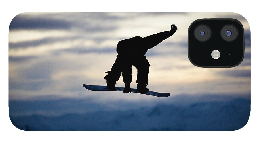 Recreational Pursuit iPhone 12 Case featuring the photograph A Male Snowboarder Does A Backside 180 #1 by Kyle Sparks