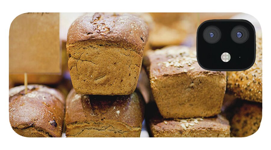 Bakery iPhone 12 Case featuring the photograph Stacks Of Fresh Bread For Sale #1 by Hybrid Images