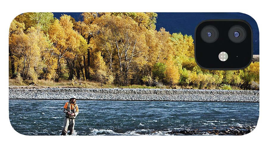 Three Quarter Length iPhone 12 Case featuring the photograph A Athletic Man Fly Fishing Stands In A by Patrick Orton
