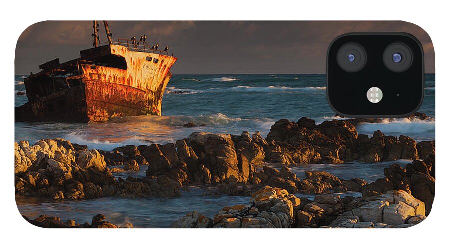Non-urban Scene iPhone 12 Case featuring the photograph A Rusting Wreck, An Abandoned Ship Off by Mint Images - Art Wolfe