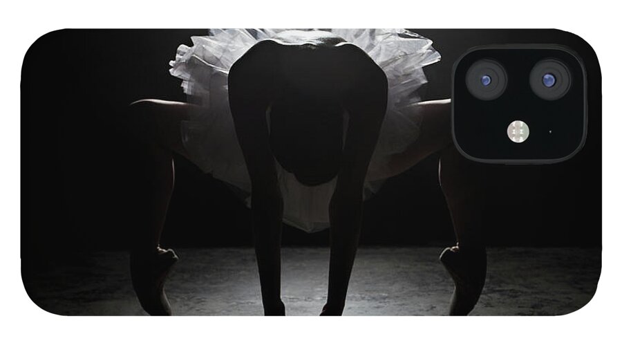 Ballet Dancer iPhone 12 Case featuring the photograph Ballerina Stretching On Stage Under by Nisian Hughes
