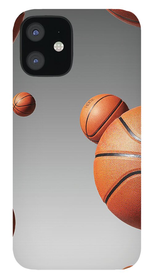 Mid-air iPhone 12 Case featuring the photograph Basketballs Floating In Air Studio Shot by Thomas Northcut