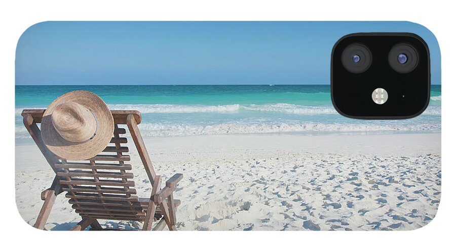 Scenics iPhone 12 Case featuring the photograph Beach Chair With A Hat, On An Empty by Sasha Weleber