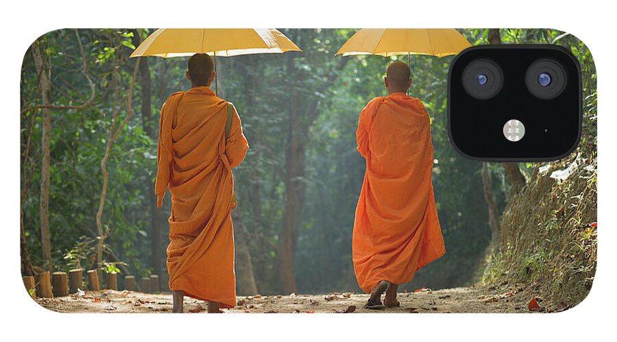 Young Men iPhone 12 Case featuring the photograph Buddhist Monks Walking Along Dirt Road by Martin Puddy