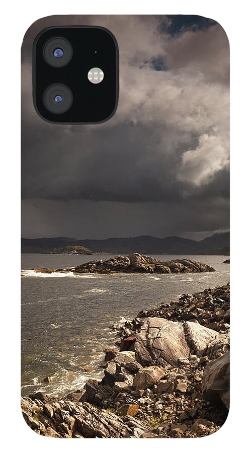 Scotland iPhone 12 Case featuring the photograph Dark Clouds Over The Water Along The by John Short / Design Pics