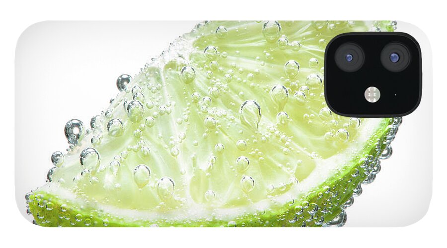 Underwater iPhone 12 Case featuring the photograph Lime Wedge With Bubbles by Chris Stein