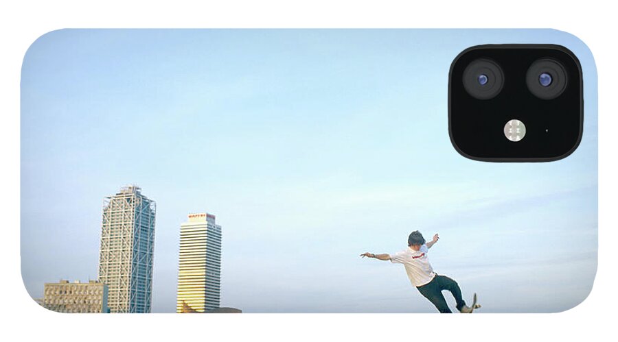 Human Arm iPhone 12 Case featuring the photograph Man Balancing Skateboard On Ramp by Paul Calver