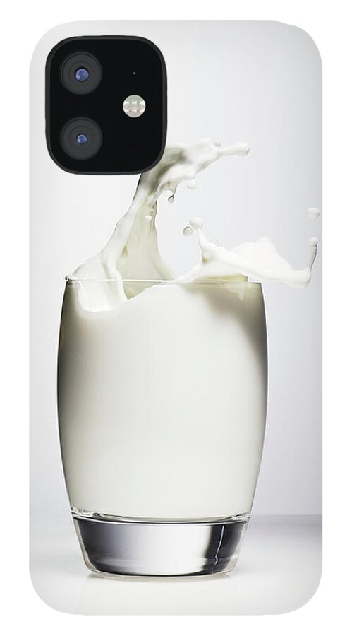 Milk iPhone 12 Case featuring the photograph Milk Splashing Out Of Drinking Glass by Henrik Sorensen