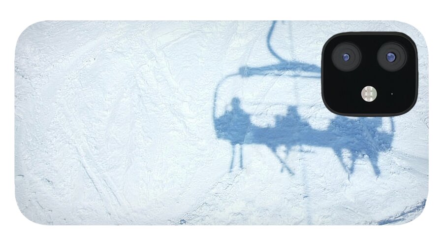 Shadow iPhone 12 Case featuring the photograph Shadow Of Skiers On Chair Lift Over by Cjp