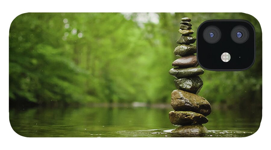 Tranquility iPhone 12 Case featuring the photograph Stack Of River Stones In Placid Water by Colin Mcdonald