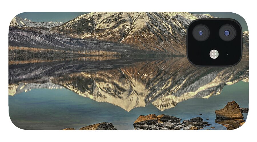 Reflections Of The Towering Mountains At Glacier National Park iPhone 12 Case featuring the photograph Reflecting Beauty by Carolyn Hall