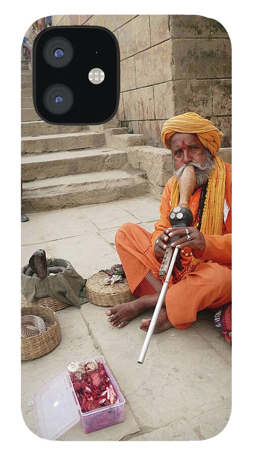 Scary iPhone 12 Case featuring the photograph Snake charmer with his snakes by Steve Estvanik