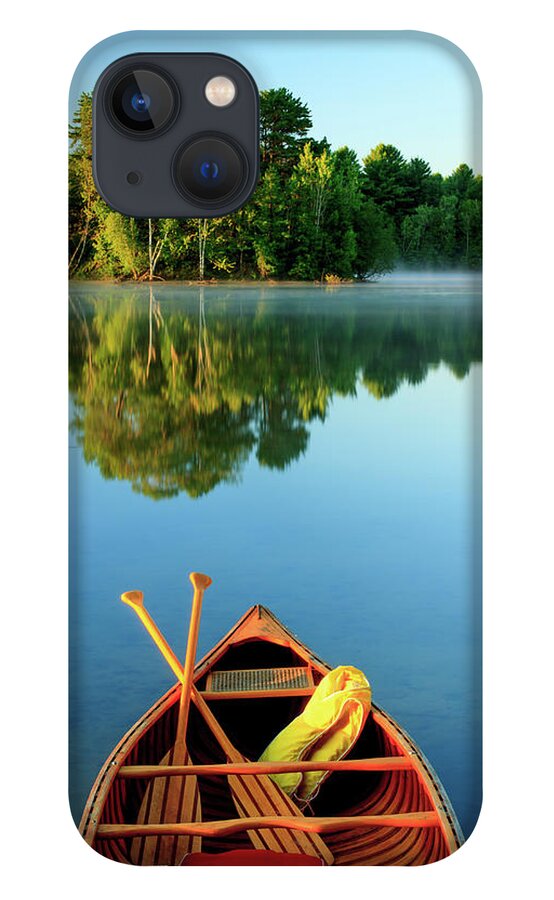 Scenics iPhone 13 Case featuring the photograph An Old Wooden Canoe On Calm Lake by Tom Whitney Photography
