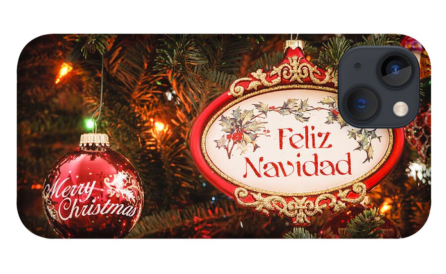 Feliz Navidad iPhone 13 Case featuring the photograph Decorated tree with Feliz Navidad and Merry Christmas ornaments by Oscar Gutierrez