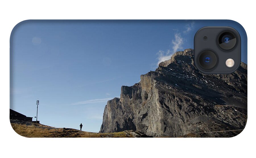 Figure iPhone 13 Case featuring the photograph Figure in the distance with mountains by Erik Burg