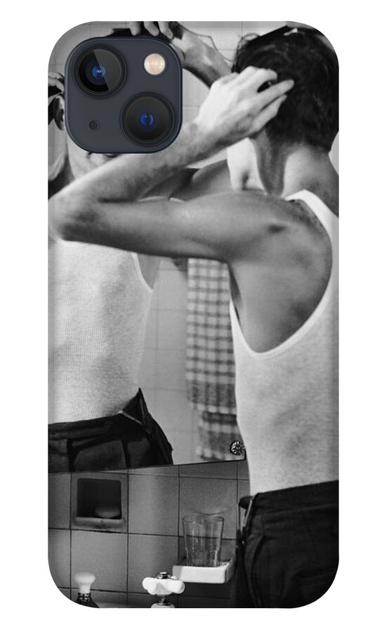 Comb iPhone 13 Case featuring the photograph Man Combing Hair In Bathroom by George Marks
