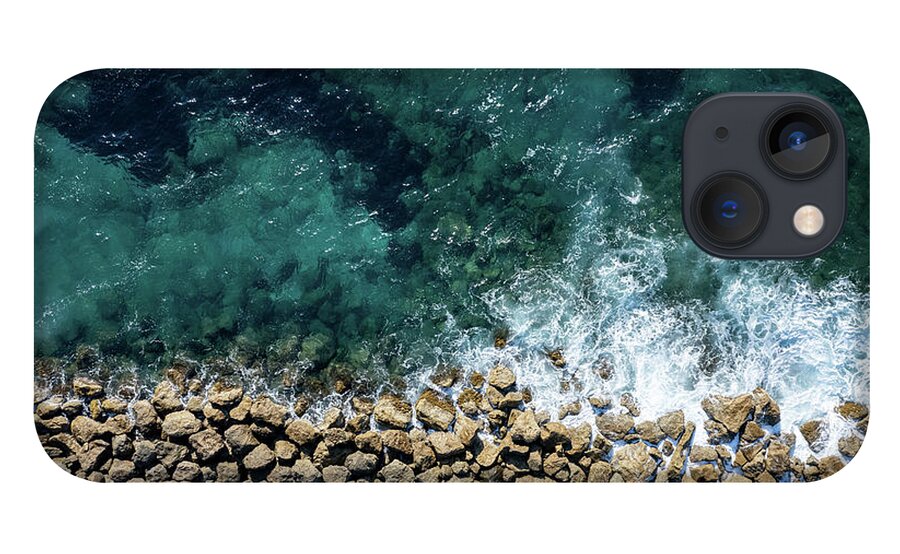Seascape iPhone 13 Case featuring the photograph Aerial view from flying drone of crystal blue ocean water and sea wall. by Michalakis Ppalis
