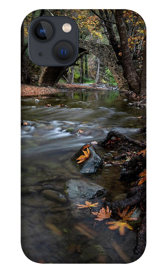 Autumn iPhone 13 Case featuring the photograph Autumn landscape with river flowing under a stoned bridge by Michalakis Ppalis