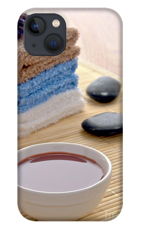 Black iPhone 13 Case featuring the photograph Hot Massage Oil with Polished Stones and Towels in a Spa by Olivier Le Queinec
