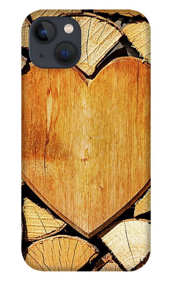 Pile iPhone 13 Case featuring the photograph Stack of firewood with a wooden heart by Bernhard Schaffer