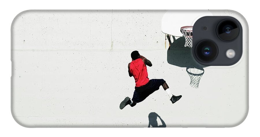 Shadow iPhone 14 Case featuring the photograph Teenage Boy 16-18 Dunking Basketball On #1 by Thomas Barwick