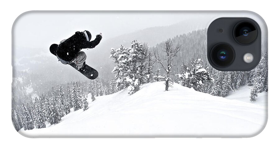 Recreational Pursuit iPhone 14 Case featuring the photograph A Man On A Snowboard Flies Through The by Derek Diluzio