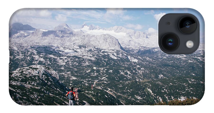 Sportive iPhone Case featuring the photograph Man with a backpack looks at the Dachstein massif by Vaclav Sonnek