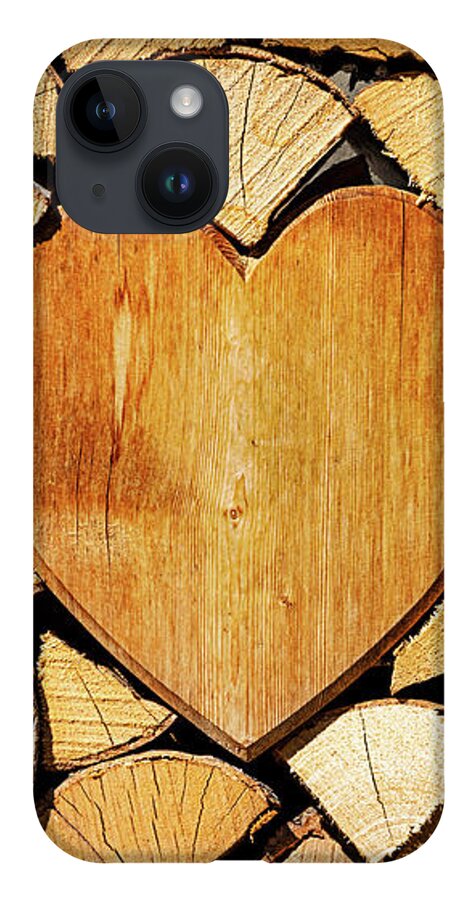 Pile iPhone Case featuring the photograph Stack of firewood with a wooden heart by Bernhard Schaffer