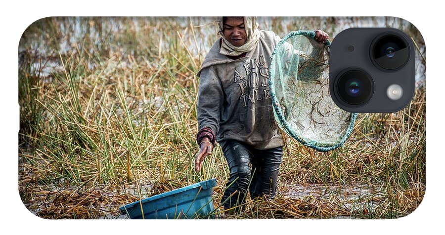 Madagascar iPhone 14 Case featuring the photograph Woman catching fish in a paddyfield - 2 by Claudio Maioli
