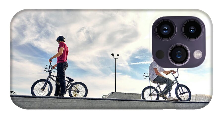 Side View Of Riders With Bmx Bikes On Concrete Ramp Against Cloudy Sky At  Skateboard Park During Sunset iPhone 14 Pro Case
