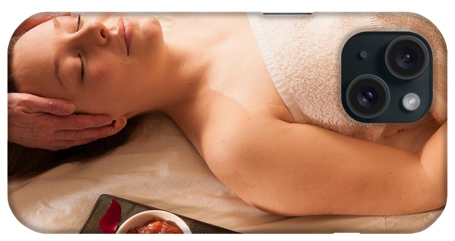 Attractive iPhone Case featuring the photograph Beautiful woman receiving a massage in a spa. #1 by Don Landwehrle