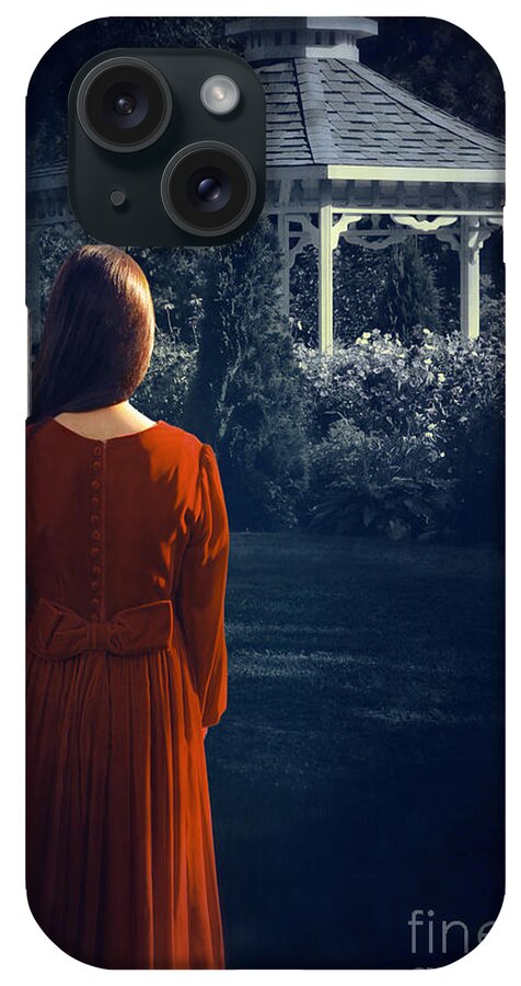 Alone iPhone Case featuring the photograph Rear view of a woman looking towards a gazebo at night #1 by Sandra Cunningham