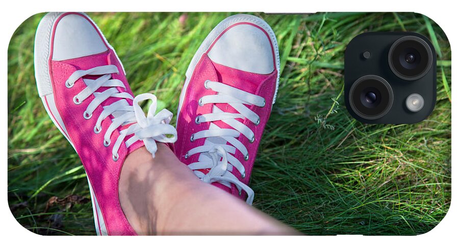 Grass iPhone Case featuring the photograph Pink sneakers on girl legs on grass #2 by Michal Bednarek