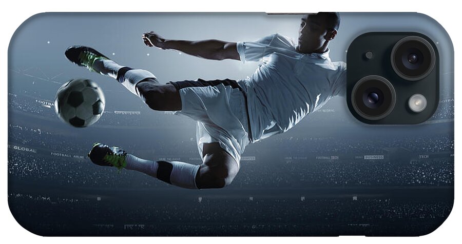 Goal iPhone Case featuring the photograph Soccer Player Kicking Ball In Stadium #4 by Dmytro Aksonov