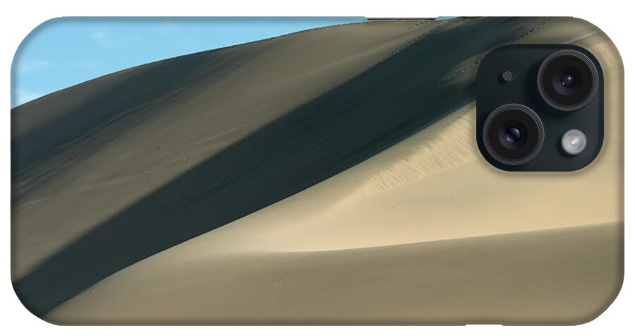 Shadow iPhone Case featuring the photograph A Large Sand Dune Against A Blue Sky by Keith Levit / Design Pics