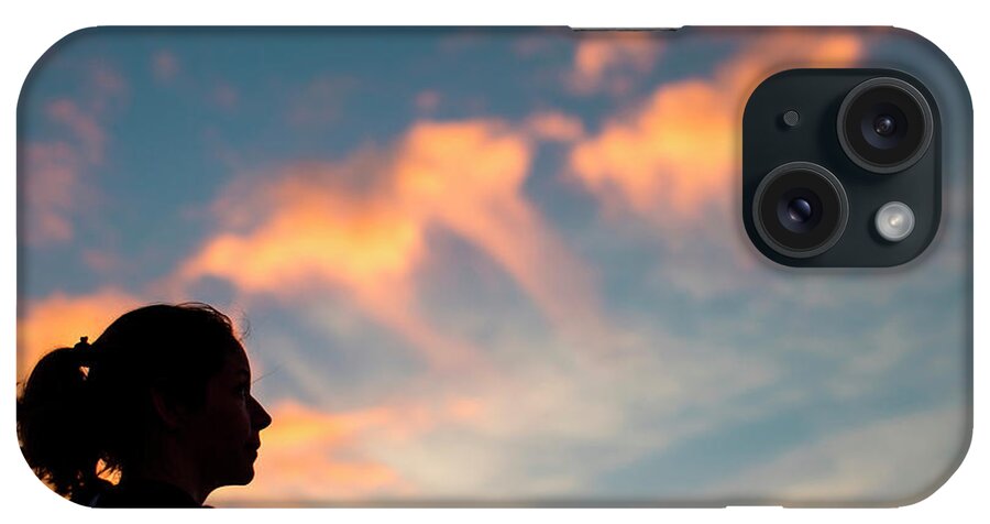 Wrightsville Beach iPhone Case featuring the photograph A Womans Head Is Silhouetted by Logan Mock-Bunting