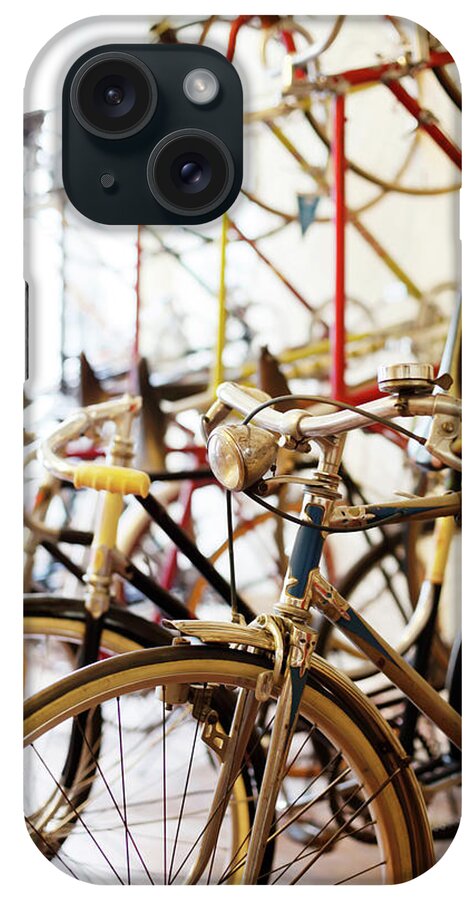 Berlin iPhone Case featuring the photograph Bicycles Parked In A Bike Shop by Alvarez