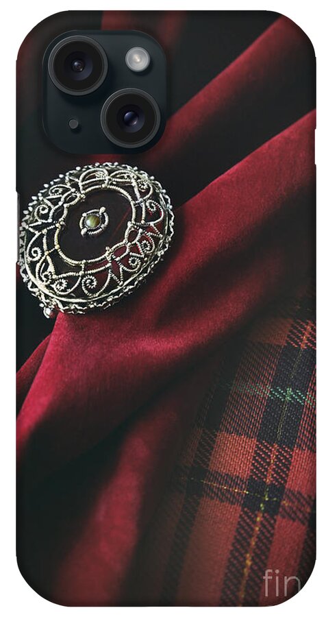 Atmosphere; Atmospheric; Ancient; Blade; Cavalier; Chevalier; Cloth; Dagger; Dark Age; Decorated; Decorative; Engraved; Engraving; Fabric; Fear; Iron; Jewellery; Jewelry; Knight-at-arms; Knights; Knives; Material; Medieval; Metal; Middle Ages; Old; Ornate; Red; Silver; Velvet; Highlander iPhone Case featuring the photograph Brooch with red velvet and green plaid by Sandra Cunningham