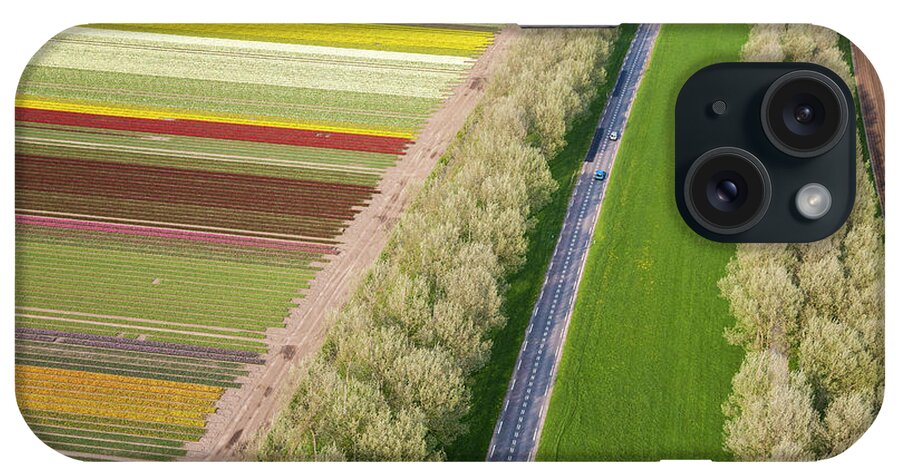Scenics iPhone Case featuring the photograph Car On Road Near Tulip Fields, Holland by Peter Adams